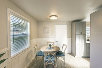 A small dining room with a table and chairs
